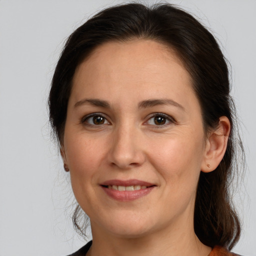 Joyful white adult female with medium  brown hair and brown eyes