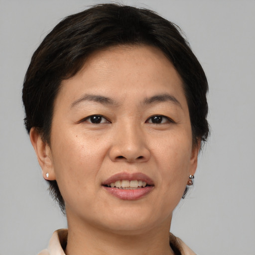 Joyful asian adult female with short  brown hair and brown eyes