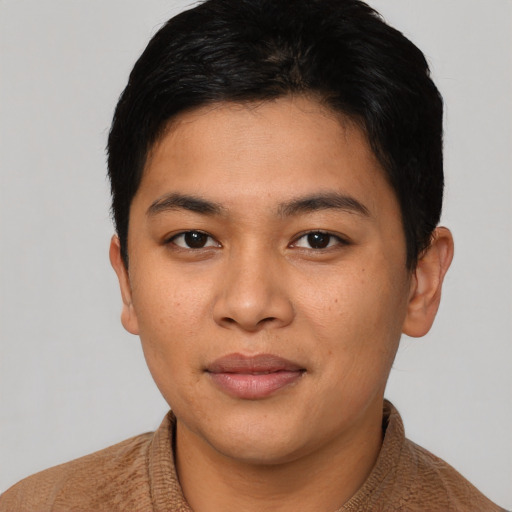 Joyful latino young-adult male with short  brown hair and brown eyes