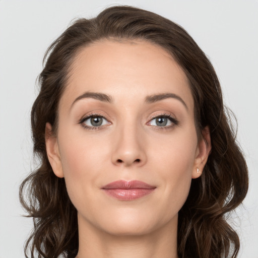 Joyful white young-adult female with long  brown hair and grey eyes