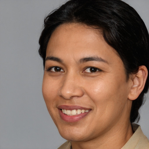 Joyful latino young-adult female with short  brown hair and brown eyes