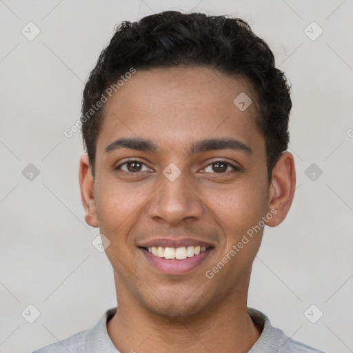 Joyful latino young-adult male with short  brown hair and brown eyes