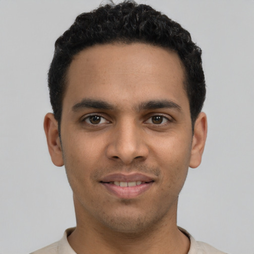 Joyful latino young-adult male with short  black hair and brown eyes