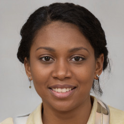 Joyful black young-adult female with medium  brown hair and brown eyes