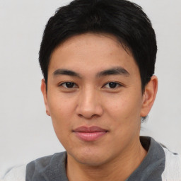 Joyful asian young-adult male with short  black hair and brown eyes