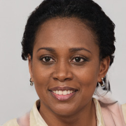 Joyful black adult female with short  black hair and brown eyes