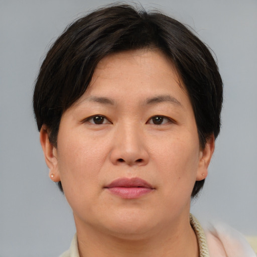 Neutral asian adult female with short  brown hair and brown eyes