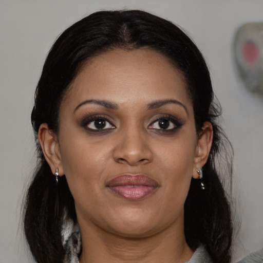 Joyful black young-adult female with medium  brown hair and brown eyes