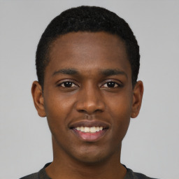 Joyful black young-adult male with short  black hair and brown eyes