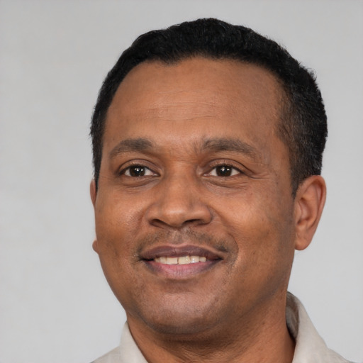 Joyful latino adult male with short  black hair and brown eyes