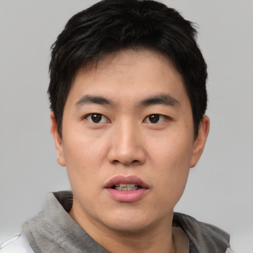 Neutral asian young-adult male with short  black hair and brown eyes