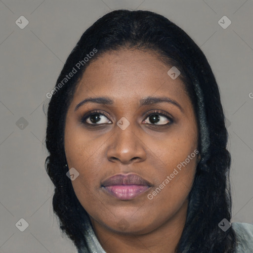 Joyful black young-adult female with long  black hair and brown eyes