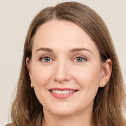 Joyful white young-adult female with long  brown hair and grey eyes