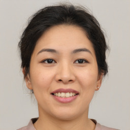 Joyful asian young-adult female with medium  brown hair and brown eyes