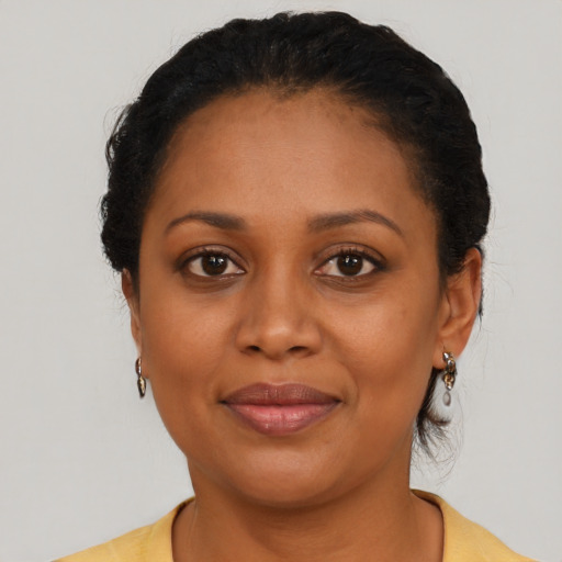 Joyful latino adult female with medium  brown hair and brown eyes