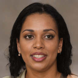 Joyful black adult female with medium  brown hair and brown eyes