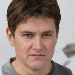 Joyful white adult male with short  brown hair and grey eyes