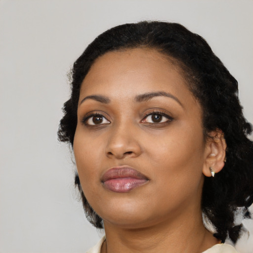 Joyful black young-adult female with medium  black hair and brown eyes