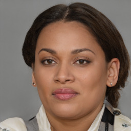 Joyful black young-adult female with medium  brown hair and brown eyes