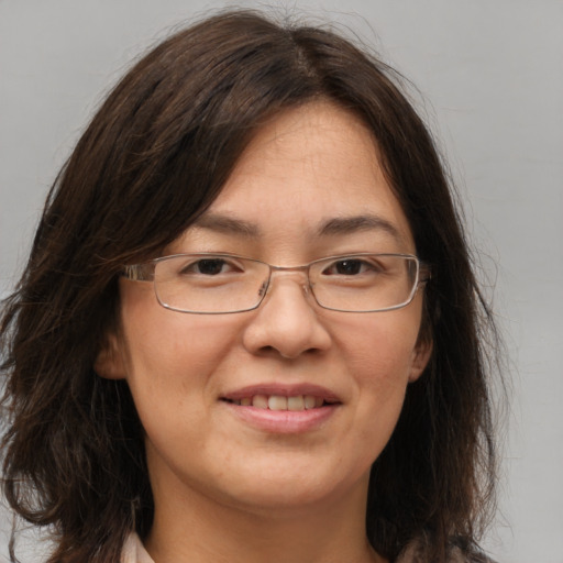 Joyful white adult female with long  brown hair and brown eyes
