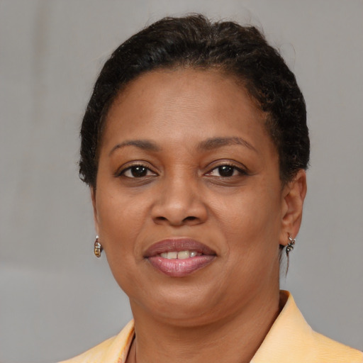 Joyful black adult female with short  brown hair and brown eyes