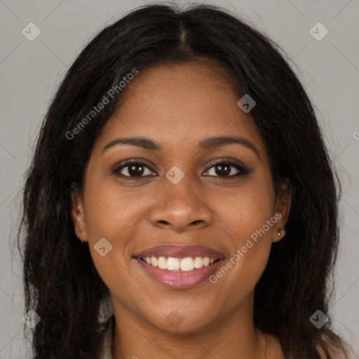 Joyful black young-adult female with long  brown hair and brown eyes