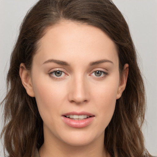 Joyful white young-adult female with long  brown hair and grey eyes