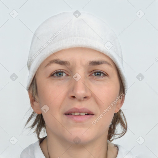 Joyful white young-adult female with medium  brown hair and grey eyes