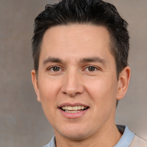 Joyful white adult male with short  brown hair and brown eyes