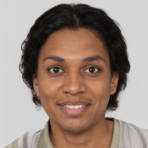 Joyful black young-adult female with short  brown hair and brown eyes