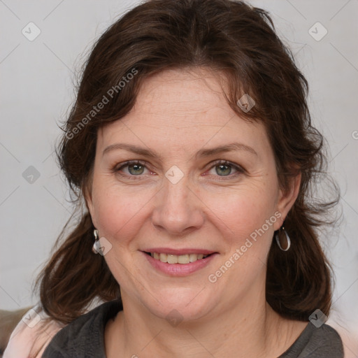 Joyful white adult female with medium  brown hair and grey eyes