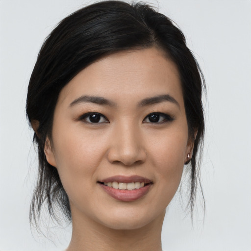 Joyful asian young-adult female with medium  brown hair and brown eyes