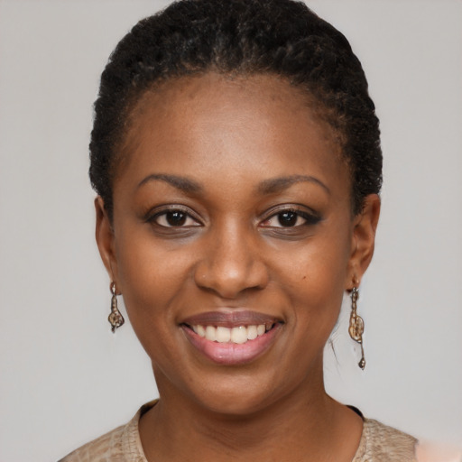 Joyful black young-adult female with short  brown hair and brown eyes