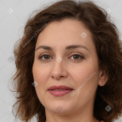 Joyful white adult female with long  brown hair and brown eyes