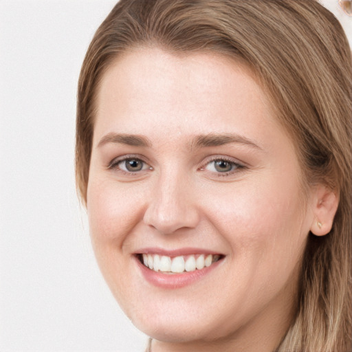 Joyful white young-adult female with long  brown hair and grey eyes