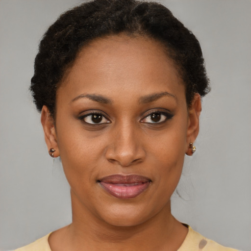 Joyful black young-adult female with short  brown hair and brown eyes