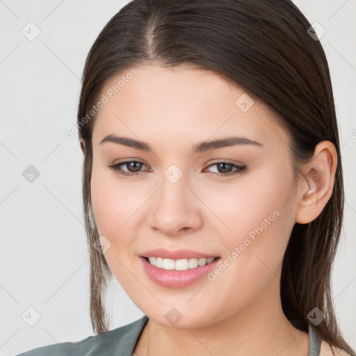 Joyful white young-adult female with long  brown hair and brown eyes