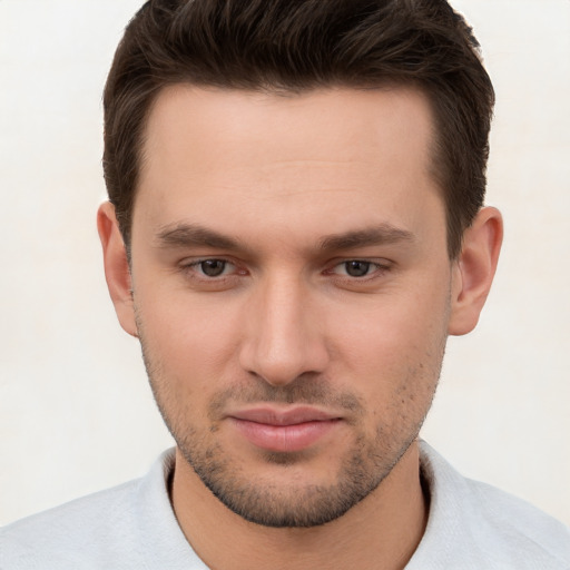 Joyful white young-adult male with short  brown hair and brown eyes