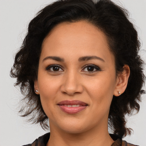 Joyful latino young-adult female with medium  brown hair and brown eyes