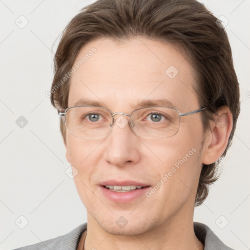 Joyful white adult male with short  brown hair and grey eyes