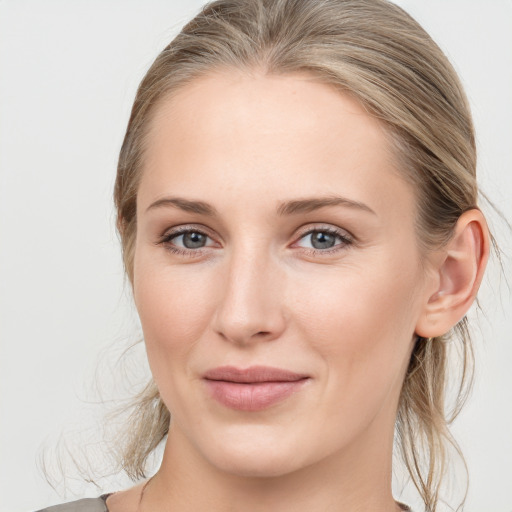 Joyful white young-adult female with medium  brown hair and blue eyes