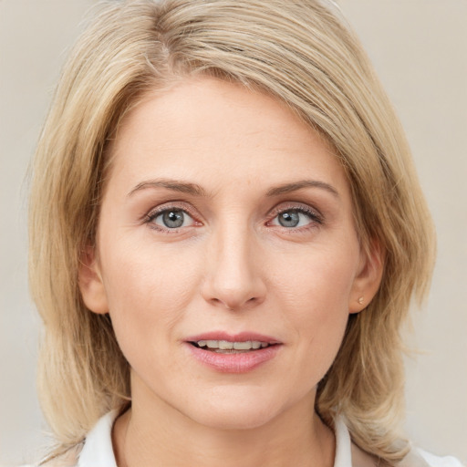 Joyful white young-adult female with medium  brown hair and blue eyes