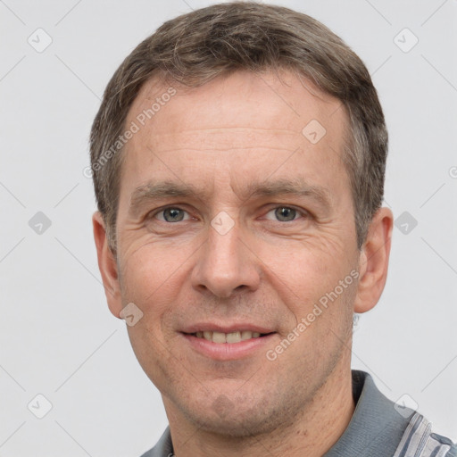 Joyful white adult male with short  brown hair and grey eyes