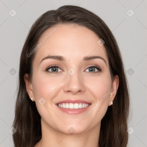 Joyful white young-adult female with long  brown hair and grey eyes