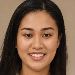 Joyful asian young-adult female with long  brown hair and brown eyes