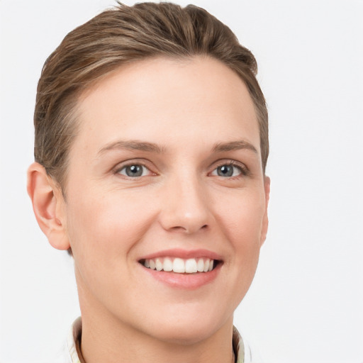 Joyful white young-adult female with short  brown hair and grey eyes