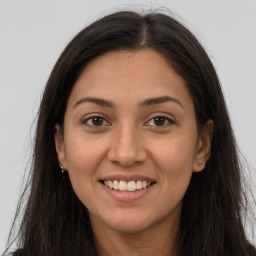 Joyful latino young-adult female with long  brown hair and brown eyes