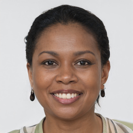 Joyful black young-adult female with short  brown hair and brown eyes