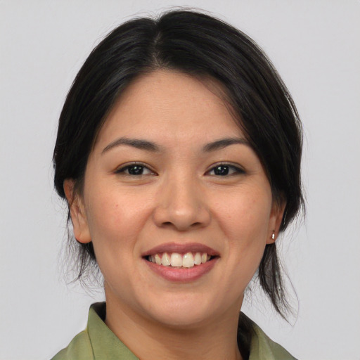 Joyful asian young-adult female with medium  brown hair and brown eyes