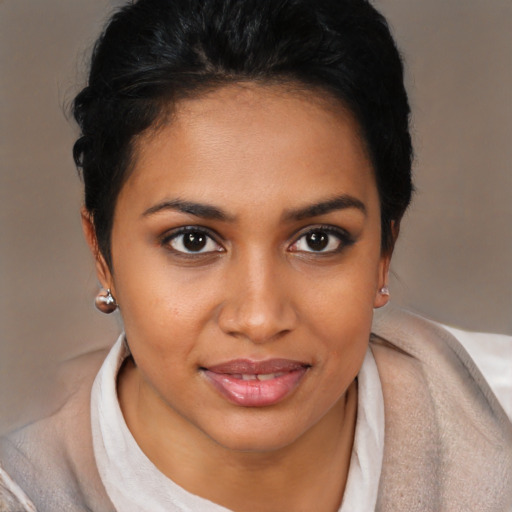 Joyful black young-adult female with short  brown hair and brown eyes